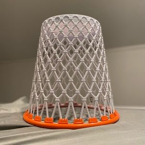 A basketball hoop trash can